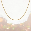 Elegant gold-tone stainless steel blade chain layered on textured paper with bokeh background - 0.3mm Hammered Round Chain 40+5cm