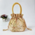 Champagne gold satin handbag with floral embroidery and drawstring closure - New Khaki
