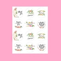Detailed view of twelve colorful floral Thank You stickers on a pink background - Colorful Floral Labels