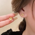 Vintage matte gold flower stud earrings shown on ear for a retro minimalist look - 132# Silver Earring Post Vintage Matte Gold Flower Earrings