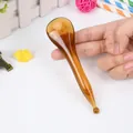 Amber resin facial massage tool for acupoint therapy and chin lifting in hand - Facial Tapping Stick / Amber