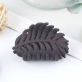 Matte dark grey leaf-shaped claw clip shown in a minimalist aesthetic lifestyle setting - Matte Leaf Style / 40x25x35mm / Dark Purple