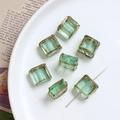 Detailed view of light green glass beads with gold edges for DIY jewelry making - Light Green