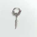 Macro detail of a vintage stainless steel ear clip featuring a carved ring and feather pendant - Dragon Feather / Earring (Pierced) / Steel