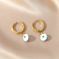 Detailed close-up of golden evil eye hoop earrings on a luxury beige silk background - White
