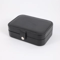 Portable black faux leather jewelry box with silver snap button for rings and earrings - Black
