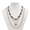 Close-up of triple-layer necklace featuring brown wood beads and silver chain with pendant - Layered Wood Bead Pendant Set / Silver