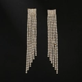 Macro detail of long tassel earrings with sparkling rhinestones on a sleek black background - G0109 Gold