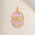 Macro detail of golden butterfly relief pendant with pink enamel and sparkling zircon - Butterfly