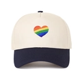 Close-up of rainbow heart embroidery on two-tone beige and navy baseball cap - Navy Blue