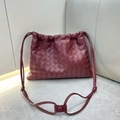 Elegant burgundy woven leather crossbody bag with drawstring closure and knotted strap detail - Burgundy
