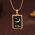 Macro shot of rectangular gold The Moon tarot pendant with black enamel and star details - Gold (X6045GD)
