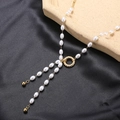 Elegant pearl necklace with a central golden twist ring detail and oval white pearls - Twisted Ring Pearl Tassel Necklace