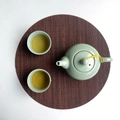Celadon teapot set with two cups on a round bamboo placemat in a top-down view - Coffee Round 25cm