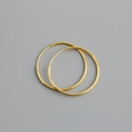 Close-up of polished gold S925 sterling silver hoop earrings on a neutral gray background - 28mm / Gold