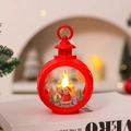 Detail of red Christmas LED lantern featuring Santa Claus with warm glowing candle light - Round Red Santa Claus