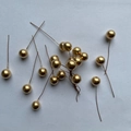 Detail of golden foam berries on wire stems for festive Christmas DIY crafts - Gold