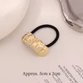 Golden textured metal elastic hair tie with minimalist crumpled pattern finish - Arched Wave Gold