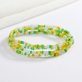 Detailed view of colorful handmade glass seed bead elastic body chain in green and yellow - Yellow Green Transparent