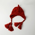 Detail of red knit baby hat featuring thick woven texture and decorative side tassels - Tassel Baby Bell Hat / Burgundy