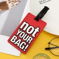 Red rectangular silicone luggage tag with white Not Your Bag text and black buckle strap - Red