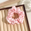 Pink and white checkered lace scrunchie with soft pleated texture on a velvet tray - Plaid Rose Red