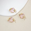 Detailed view of pink heart pendants with gold star accents and crystal zircons - Lotus Pink