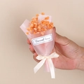 Close-up of mini orange dried baby's breath bouquet with beige ribbon and eternal love tag - Style 12 Orange Gypsophila Bouquet