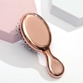Mini rose gold metallic hairbrush with white-tipped black bristles and oval shape - Electroplated Bright Gold