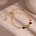 Detail of adjustable gold-plated chain bracelet with zircon square and black enamel charm - Gold Zircon Geometric Bracelet