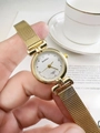 Close-up of vintage gold quartz watch with a metal mesh band and elegant gold dial - Gold Steel Strap White Dial