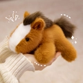 Cute plush pony doll in brown and white, held in hand, soft stuffed animal for children - Pony