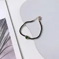 Elegant gold-plated bracelet featuring black beads and a green heart zircon pendant - Green Heart Bracelet (A2132)