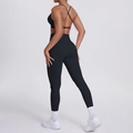 Detail of black sports set featuring cross back bra and high-waist seamless leggings - S / Black