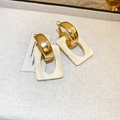 Dettaglio di ganci per orecchini geometrici dorati con ciondoli in resina marmorizzata - Oro & Bianco Crema