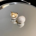 Elegant gold-plated round pearl earrings with white pearlescent finish on a mirror base - Pearly Round Ear Buckle / White