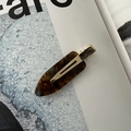 Macro shot of tortoiseshell acetate seamless hair clip on a fashion magazine background - No-Crease Hair Clips / Blue Coffee