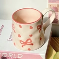 Beige ceramic mug with pink bow and heart patterns including a matching spoon - Bow Mug (No Spoon)