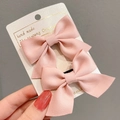 Detail of two pink satin bow hair clips on a handmade card display with metal duckbill clips - Korean Pink
