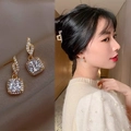 Detail of square-cut clear crystal drop earrings with pavé rhinestones in gold finish - Square Dangle Pave Rhinestone Style (A04)
