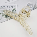 Detail of a large champagne translucent claw clip with strong spring and acrylic finish - Dark Champagne