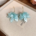 Detailed close-up of light blue resin flower earrings with gold hooks on a linen tray - Light Blue Petal Earring Hook (4# Silver Earring Post)