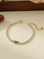 Detail of gold tennis bracelet with emerald green stone and sparkling cubic zirconia - Green Rectangular Style (ZHB697 Green)