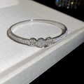 Detailed macro of silver plated bangle with pave zircons and hollow floral motif - 4# Silver Hollow Clover Style (4#)