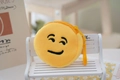 Close-up of a yellow plush emoji coin purse with black embroidered smiley face and zipper - Style 8 (Single Wink)