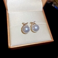 Gold plated pearl stud earrings with crisscross diamond detail in an orange jewelry box - Gold Cross Zircon Pearl Studs (72# Silver Earring Post)