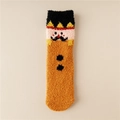 Detail view of plush coral fleece Christmas socks featuring cartoon character embroidery - One Size / Orange
