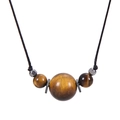 Macro detail of natural tiger eye beads and metal spacers on a black cord necklace - Tiger Eye - Necklace