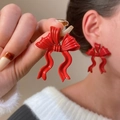 Detailed close-up of glossy red bow-knot stud earrings showing the vibrant lacquer finish - Wine Red Large Bow Knot (11789)