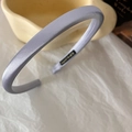 Close-up of a light purple satin fabric headband on a soft white background - Fog Blue